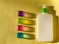 Cosmetic bottle and multicoloured translucent cubes. Colourful shadows