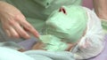 Cosmetician applying alginate facial mask.