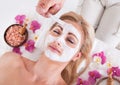 Cosmetician applying facial mask on face of woman Royalty Free Stock Photo