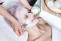 Cosmetician applying facial mask to the face Royalty Free Stock Photo