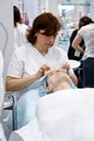 Cosmetician doing cosmetic mask