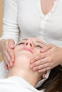 Cosmetician giving customer face massage