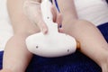 Cosmetician hands make laser hair removal depilation procedure on woman leg closeup photo