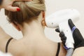 Cosmetician hands make laser hair removal depilation procedure on woman neck closeup photo
