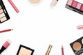 Cosmetics from above border on white background. Blusher, face powder container, eyebrow shadow, nail polish, lip gloss and pencil Royalty Free Stock Photo