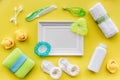 Cosmetics for baby bath, frame, towel and toys on yellow background top view space for text Royalty Free Stock Photo