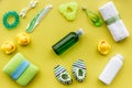 Cosmetics for baby bath, towel and toys on yellow background top view pattern Royalty Free Stock Photo