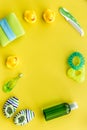 Cosmetics for baby bath, towel and toys on yellow background top view space for text Royalty Free Stock Photo