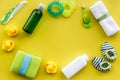 Cosmetics for baby bath, towel and toys on yellow background top view space for text Royalty Free Stock Photo