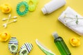 Cosmetics for baby bath, towel and toys on yellow background top view space for text Royalty Free Stock Photo