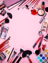 Cosmetics background. Top view. makeup brushes and cosmetics on a pink background. Professional set