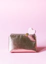 Cosmetics bag and small bath bomb in the shape of heart on soft pastel background Royalty Free Stock Photo