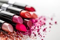 Cosmetics and beauty industry, a set of lipsticks on a background of loose powder and eye shadow, High Angle Still Life of Four