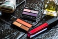 Cosmetics on a black, nail polish, eye shadow palette, lipstick, brush, parfume Royalty Free Stock Photo