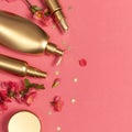 Cosmetics Branding Concept. Cosmetics, spring pink flowers, gold stars confetti on pink background. Cosmetic mock up gold bottles