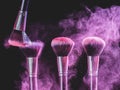 Cosmetics brush and explosion colorful makeup powder background - beauty make-up product and mineral cosmetic concept Royalty Free Stock Photo