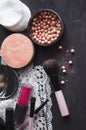 Cosmetics on a dark background, close-up. Face care, make-up. Items for applying makeup. The world of a woman