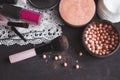 Cosmetics on a dark background, close-up. Face care, make-up. Items for applying makeup. The world of a woman