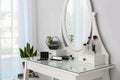 Cosmetics on dressing table with mirror. Stylish room interior Royalty Free Stock Photo