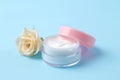 Cosmetics for face and body. Cream in pink bottles with fresh roses on a gentle blue background. creams and lotion. spa Royalty Free Stock Photo