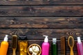 Cosmetics for hair care with jojoba, argan or coconut oil and shampoo in bottle on wooden background top view copyspace