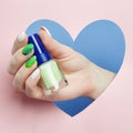 Cosmetics hand makeup, beautiful nails manicure, nail Polish, advertising on colored paper background. Fingers with bright colored