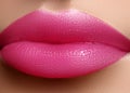 Cosmetics, makeup. Bright lipstick on lips. Closeup of beautiful female mouth with pink lip makeup. Sweet kiss Royalty Free Stock Photo