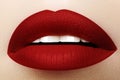 Cosmetics, makeup. Bright lipstick on lips. Closeup of beautiful female mouth with red lip makeup. Part of face Royalty Free Stock Photo