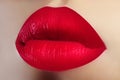 Cosmetics, makeup. Bright lipstick on lips. Closeup of beautiful female mouth with red lip makeup. Valentine sweet kiss