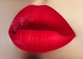 Cosmetics, makeup. Bright lipstick on lips. Closeup of beautiful female mouth with red lip makeup. Valentine sweet kiss