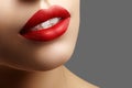 Cosmetics, makeup. Bright lipstick on lips. Closeup of beautiful female mouth with red and pink lip makeup. Part of face Royalty Free Stock Photo