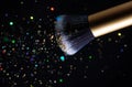 Cosmetics makeup brush and powder dust explosion background. Royalty Free Stock Photo