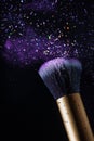 Cosmetics makeup brush and powder dust explosion background. Royalty Free Stock Photo