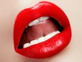 Cosmetics and makeup. Red lip gloss and lipstick. Fashion lip makeup. Sensual female mouth Royalty Free Stock Photo