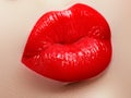 Cosmetics and makeup. Red lip gloss and lipstick. Fashion lip makeup. Sensual female mouth Royalty Free Stock Photo