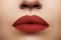 Cosmetics, makeup. Bright lipstick on lips. Closeup of beautiful female mouth with red lip makeup. Clean skin model Royalty Free Stock Photo