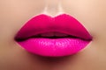 Cosmetics, Makeup. Bright Lipstick on Lips. Closeup of Beautiful Female Mouth with Fashion Pink Lip Makeup. Part of face