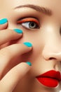 Woman`s face with vivid make-up and colorful nail polish Royalty Free Stock Photo