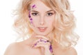 Cosmetics and manicure. Close-up portrait of attractive woman with dry flowers on her face, pastel color of nail design Royalty Free Stock Photo