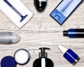 Cosmetics for men flatlay frame. Various male grooming cosmetic products on shabby whitewashed wooden background, copy space