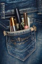 Cosmetics and money sticks out of the pocket of his jeans with r Royalty Free Stock Photo