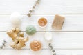 Cosmetics with natural herbal and ginger ingredients on white wooden background top view