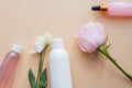 Cosmetics from natural ingredients and extracts of flowers and roses on a beige background. Cream, lotion, gel in white tubes with Royalty Free Stock Photo