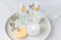 Cosmetics packaging. Set of different cosmetic bottles of cream or serum on a ceramic tray. Blank packaging. Natural beauty spa Royalty Free Stock Photo