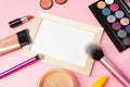 Cosmetics is on the pink backgroud. Makeup with a frame in close view. Concealer, brush, eyeshadow with a frame are on the