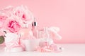 Cosmetics products for bath, spa - essential oil, bath salt, cream, liquid soap, towel and pink roses in delicate pastel pink. Royalty Free Stock Photo