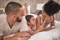 Cosmetics, relax and happy family on a bed with the child having fun with a makeup brush, laughing and playing. Mother Royalty Free Stock Photo