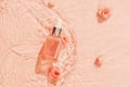 Cosmetics on water background of trendy peach colour