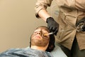 Cosmetologist apply carbon nanogel to face client