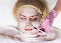 Cosmetologist applying facial mask to problem skin. young woman having skin procedures cleaning Royalty Free Stock Photo